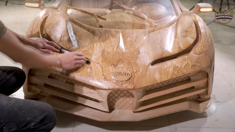 Witness the Bugatti Centodieti being carved out of wood.